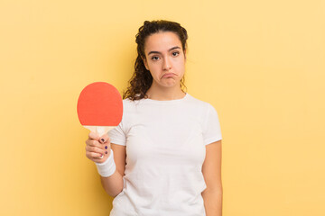 young pretty hispanic woman feeling sad and whiney with an unhappy look and crying. ping pong...