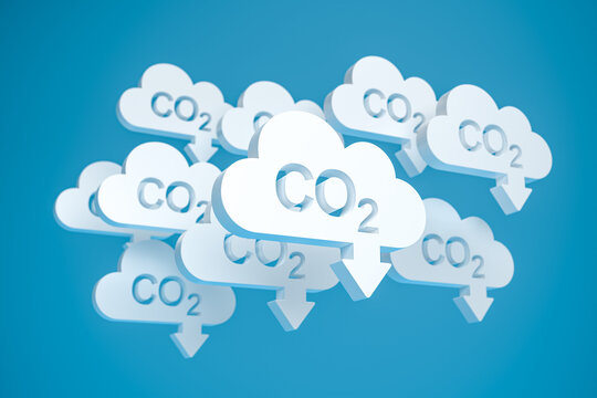 CO2 reduction concept. Cloud shaped objects with the word CO2 punched out and an arrow pointing down in front of a blue background.