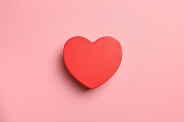 Gift heart  shape red box on pink background. Top view, gift card.