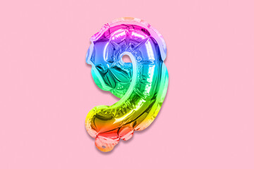 Rainbow foil balloon number, digit nine on a pink background. Birthday greeting card with...