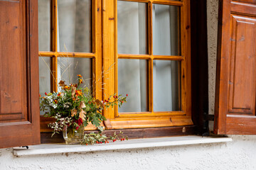Autumn bouquet on a window of a cottage house as decoration