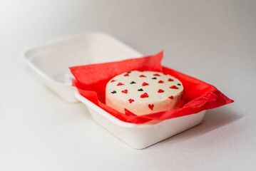 Red velvet heart shaped Valentine day bento cake, sweet dessert surprise gift for Valentines day top view. In box