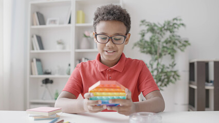 School kid playing pop it game, having fun, child's attention, mental break