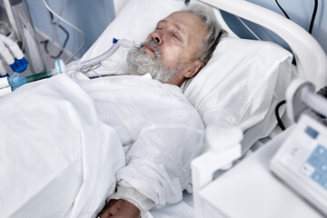 caucasian senior man patient lying on bed at hospital ward. Lonely old man sleeping in Nursing...