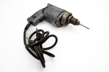 Vintage Electric Drill Showcased With A White Background. A solid metal vintage corded electric drill with drill bit ready for use.