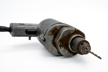 Vintage Electric Drill Showcased With A White Background. A solid metal vintage corded electric drill with drill bit ready for use.