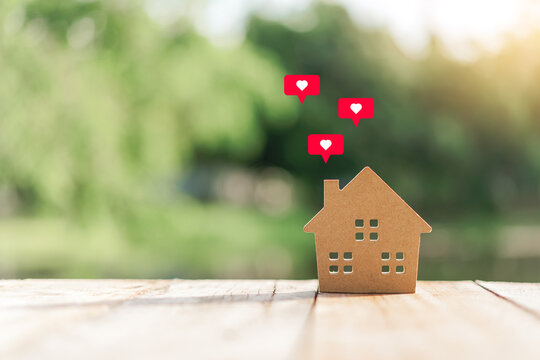 Small model house with heart icon flying abstract background. Home sweet home and lovely family concept.