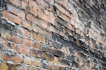 Backside Of An Exterior Brick Wall. The grout is visibly protruding through the spaces between the bricks.