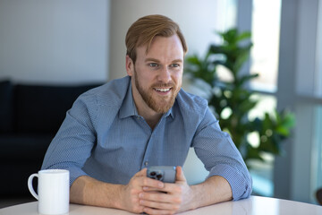 Man at home using cellphone