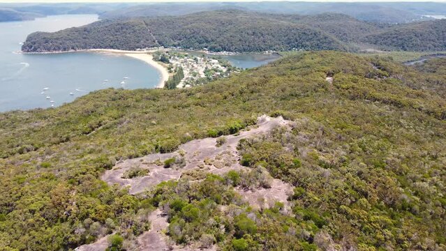 Aerial drone pan shot of Elephant Rock formation Patonga Beach Bay National Park Bushland tourism Central Coast NSW Australia 4K
