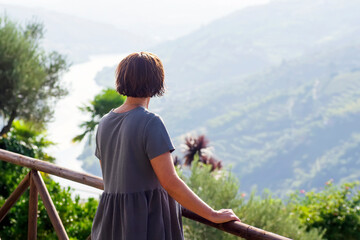 woman looking  Vale do Douro valley  in Portugal , Europe , world heritage site , focus in...