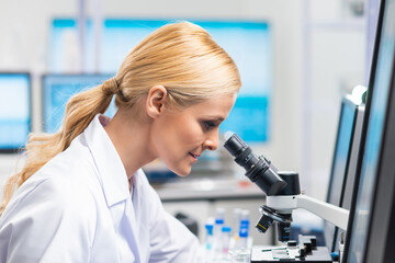 Professional female scientist is working on a vaccine in a modern scientific research laboratory. Genetic engineer workplace. Future technology and science.