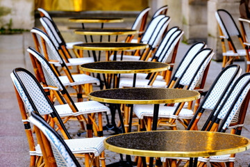 wet tables and chairs in the row - french restaurant - 484188155