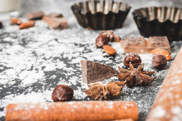 Baking concept, cupcake form and food ingredients on a dark background, prepare for cooking