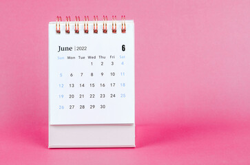 Obraz na płótnie Canvas June 2022 desk calendar on pink background.