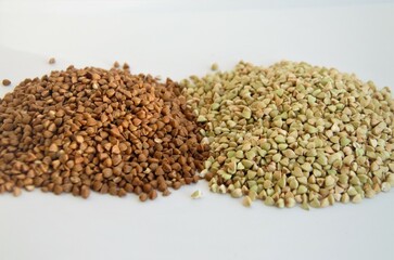 cereals of buckwheat and green unboiled buckwheat on a white background