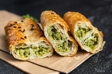 rollini phyllo pastry spinach, cheese, cream cheese savory pastries ready to eat fresh portion dietary healthy meal food diet still life snack on the table copy space food background rustic top view