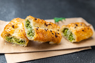 rollini phyllo pastry spinach, cheese, cream cheese savory pastries ready to eat fresh portion dietary healthy meal food diet still life snack on the table copy space food background rustic top view