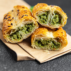 rollini phyllo pastry spinach, cheese, cream cheese savory pastries ready to eat fresh portion dietary healthy meal food diet still life snack on the table copy space food background rustic top view