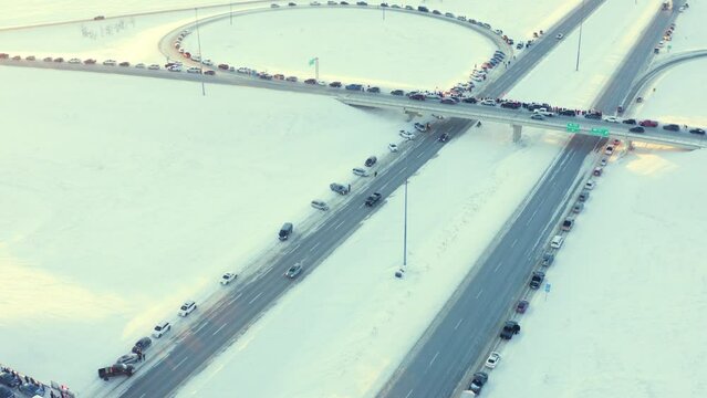 Aerial view of Freedom Convoy 2022 as they pass through Manitoba Canada.  Thousands of people lined up in support of this protest.