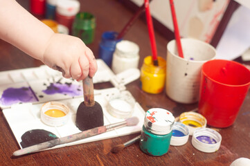 Caucasian toddler boy painting at home real life candid pictures