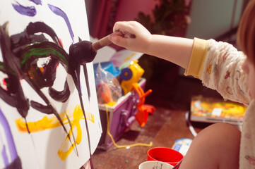 Caucasian toddler boy painting at home real life candid pictures