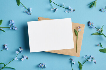 Wedding invitation or greeting card mockup with envelope and flowers