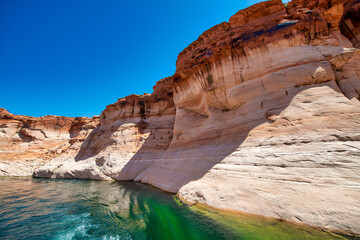 Cruise along Lake Powell. View of narrow, cliff-lined canyon from a boat in Glen Canyon National Recreation Area, Arizona..