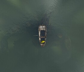 Rowing boat and person with a huge underwater creature beneath the surface © GARETH