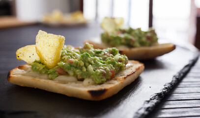 healthy breakfast. toasted italian ciabatta bread with melted cheese and avocado puree