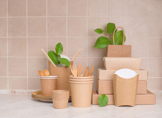 Eco friendly food containers from paper and branches with leaves on kitchen table. Plastic free. Zero waste.