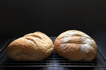 delicious homemade butter bread is on wooden black table with black cement wall backgound of the bakery shop in the morining during Christmas