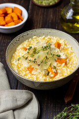 Risotto with pumpkin, cheese and thyme. Vegetarian food. Healthy eating.