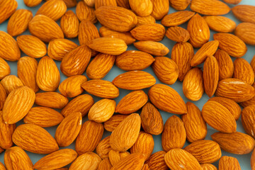 Almonds isolated. Walnuts on green background. Brazilian nuts Almond. Arranged on a light green background. Macro. Copy space