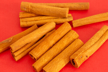 Cinnamon flavor closeup Aromatic Cuisine. On red background. Top view. With copy space