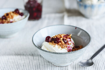 Cherry sauce, cream cheese and feta cream and crumble crust dessert. Homemade Sweet and salty cheesecake. Trifle. Selective focus