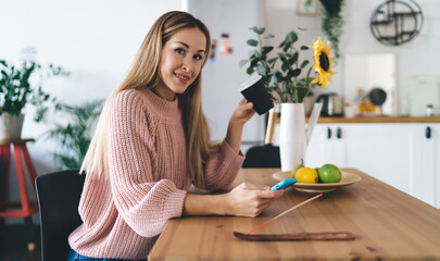 Girl using smartphone and drinking coffee at home