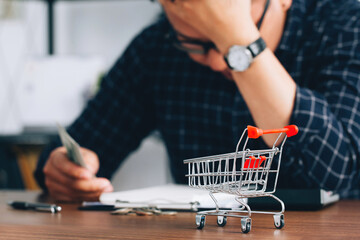Man holding his forehead while having headache due to higher food prices from inflation.Rising food and grocery store prices and expensive daily consumer goods concept. The problem of inflation