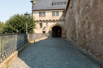 Courtyard entrance to a castle. Lantern in the foreground