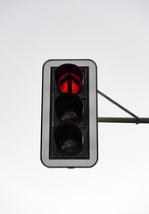 German traffic lights “Ampel“ with red flash light shining isolated on white sky. Red light...