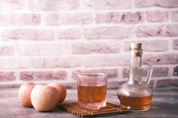 apple vinegar in glass bottle with fresh green apple on table 