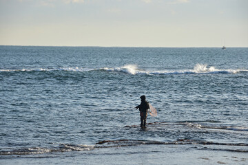 Fototapeta na wymiar A korean fisherman fishing on the rock in the seaside.