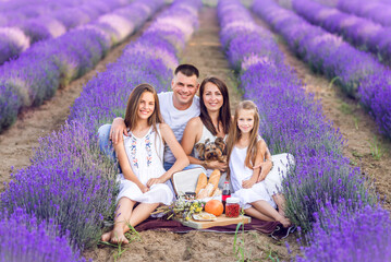 Family picnic in the lavender field. Happy family in nature in summer