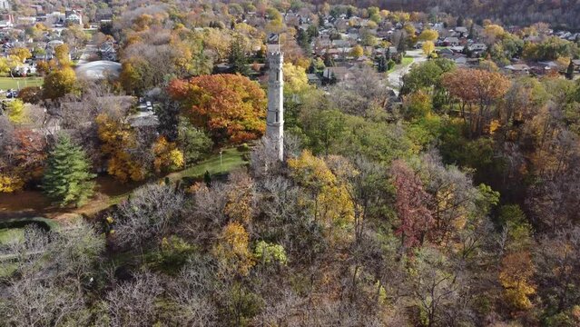 Aerial footage battlefield house monument in Hamilton Ontario Canada, drone close up of the main stone tower in the park