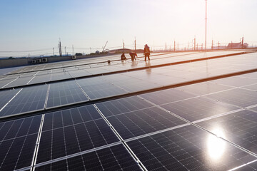 Engineer and service man installation solar cell on the roof of the factory, solar farm energy,...
