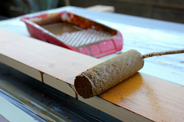 varnishing wooden slats with roller