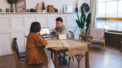 Couple planning vacation or journey at table