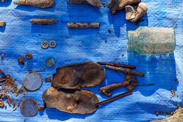 Human remains on blue burlap. Archaeological excavations of forensic bones for examination. Background