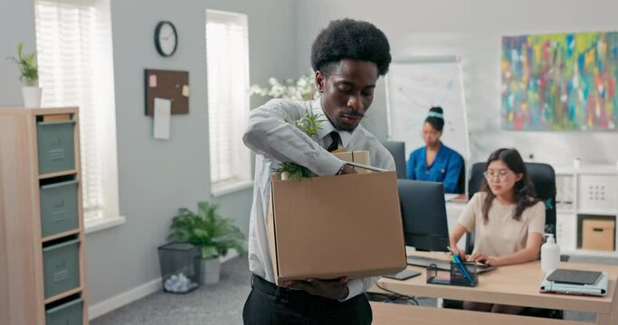 Man with afro hair quits corporate job leaves office with things packed in box leaves corporate, checks to make sure he took everything, quits job, retires, happy smiling