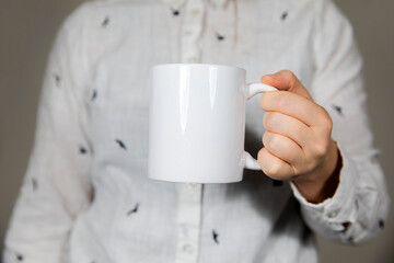 Girl holding blank white coffee mug , white porcelain mug mock up, coffee, tea, milk or soda, copy space